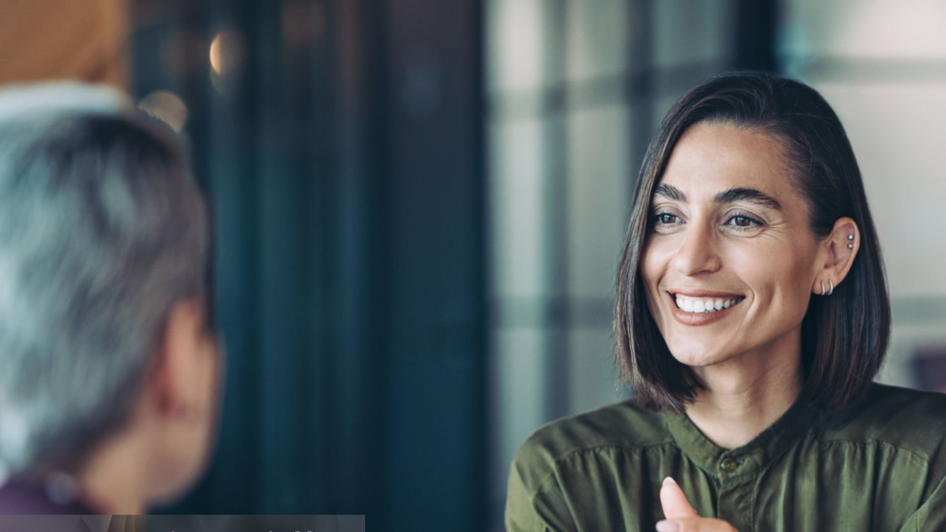 Two people talking and smiling